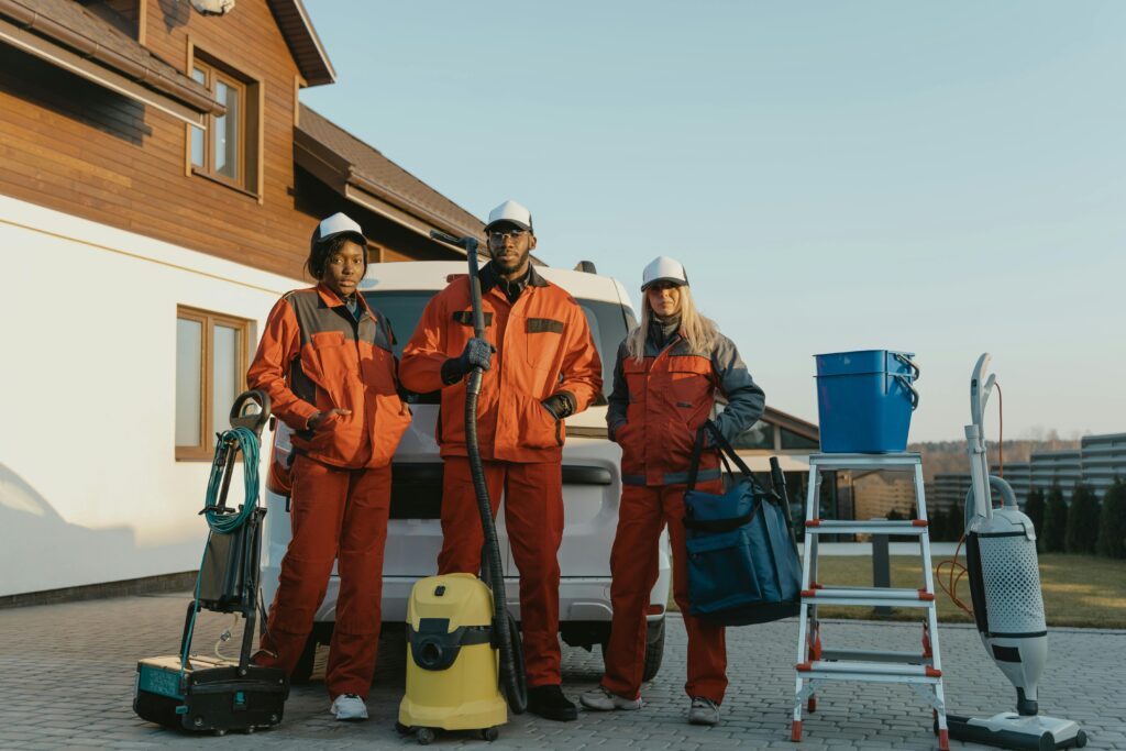 pexels-photo-6196238-6196238 3 Men in Orange Jacket and Helmet Standing Beside White and Yellow Water Jug
