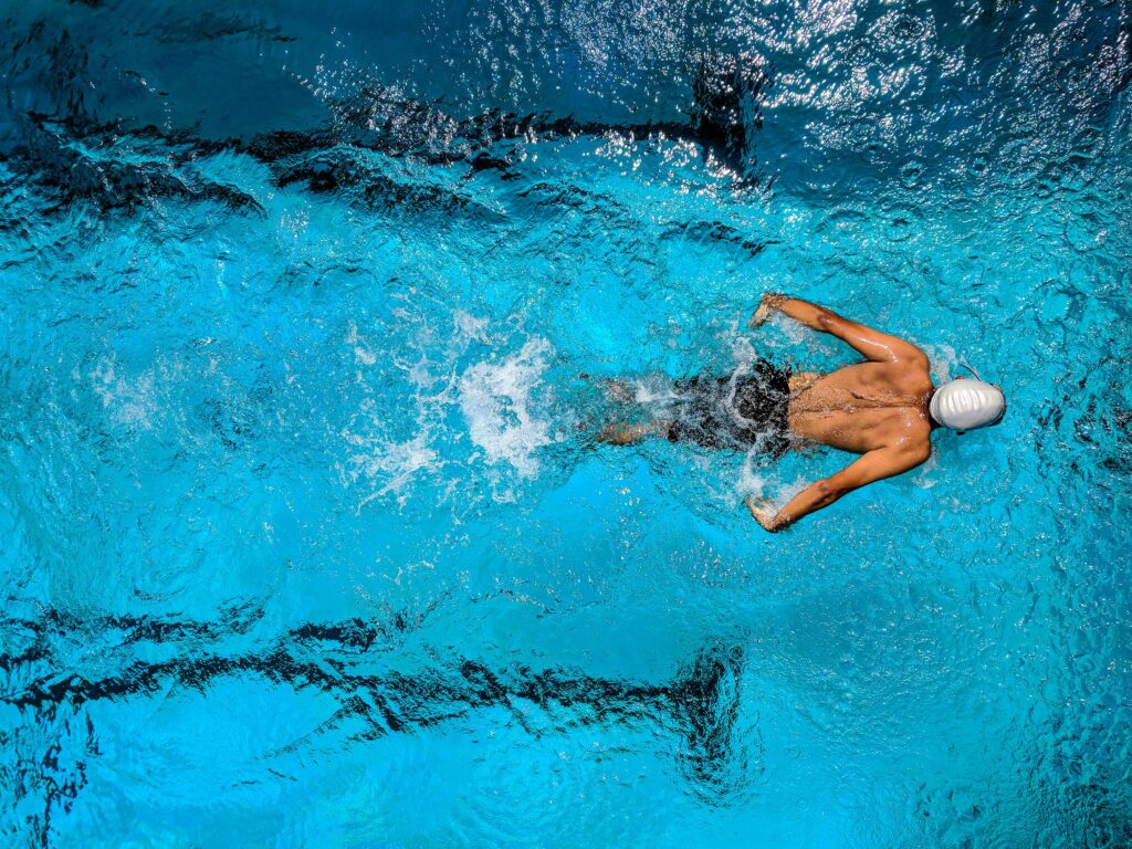 pexels-photo-863988-863988 Person Swimming on Body of Water